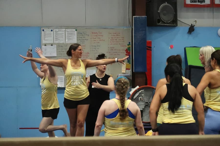 jen pelland coaching on beam at adult gymnastics camp
