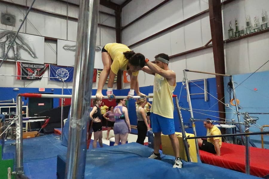 coach joe spotting on bars at adult gymnastics camp 2025 in nh