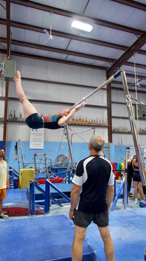 yuriy teaching a kip at the original adult gymnastics camp 2025